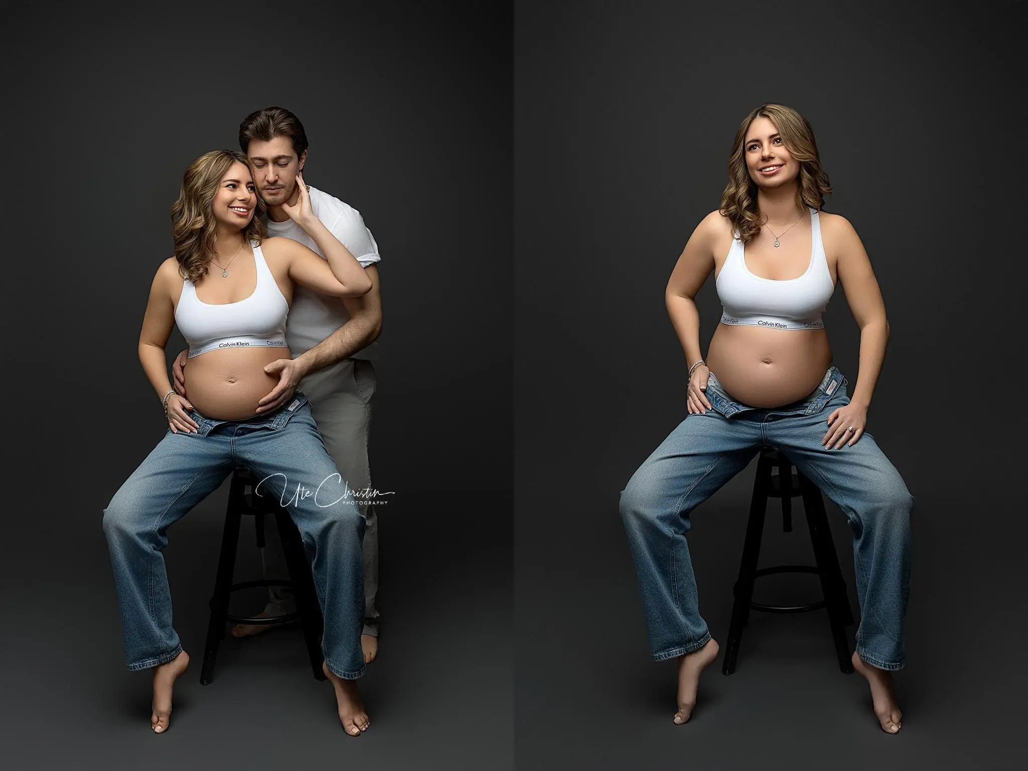 A pregnant woman in a white sports bra and blue jeans poses on a stool against a dark background, embodying the serene anticipation often fostered by birthing centers in Connecticut. In one image, a man kneels behind her, gently touching her face and belly. Both appear happy and relaxed.