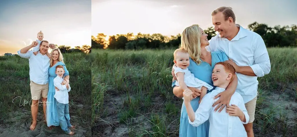A smiling family of four stands in tall grass at sunset. The parents, holding their young children, are dressed in light blue and white—embracing and laughing together in a natural setting, just like those cared for by Pediatric Dentists In Milford CT.