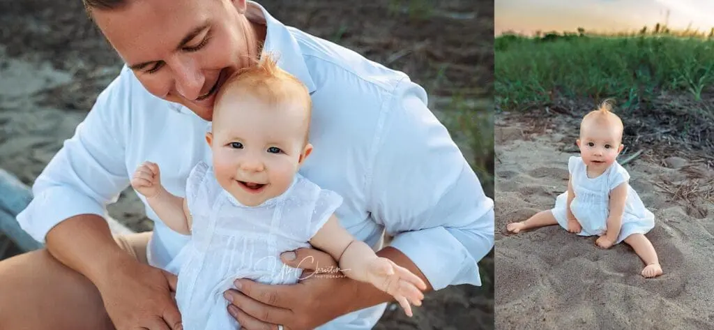 A man in a white shirt holds a smiling baby girl in a white dress outdoors; next to them, the baby sits alone in the sand with grass in the background at sunset—capturing moments families cherish near Pediatric Dentists In Milford CT.