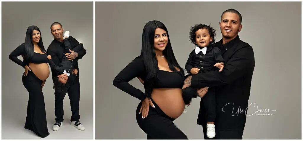 A pregnant woman in a black dress poses with a man in black and their toddler. In one photo, the man holds the child upside-down; in the other, he holds the child upright. All are smiling against a gray backdrop.