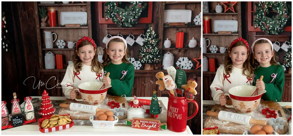 Two smiling girls in festive sweaters and headbands bake Christmas cookies in a decorated kitchen with holiday mugs, eggs, cookies, and baking supplies on the counter. Holiday decor and wreaths are in the background.