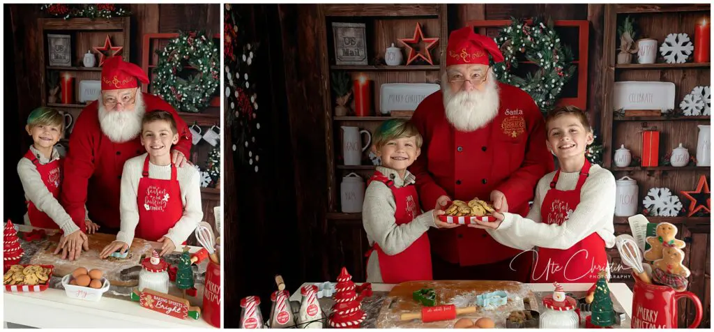 Two smiling children in red aprons bake cookies with Santa Claus in a festive kitchen decorated for Christmas, with holiday treats and baking ingredients on the table.